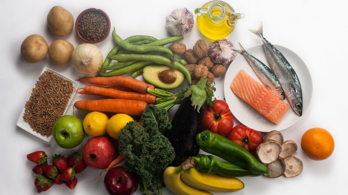 Assortment of various food groups: proteins, fats, fruit, vegetables and carbohydrates.