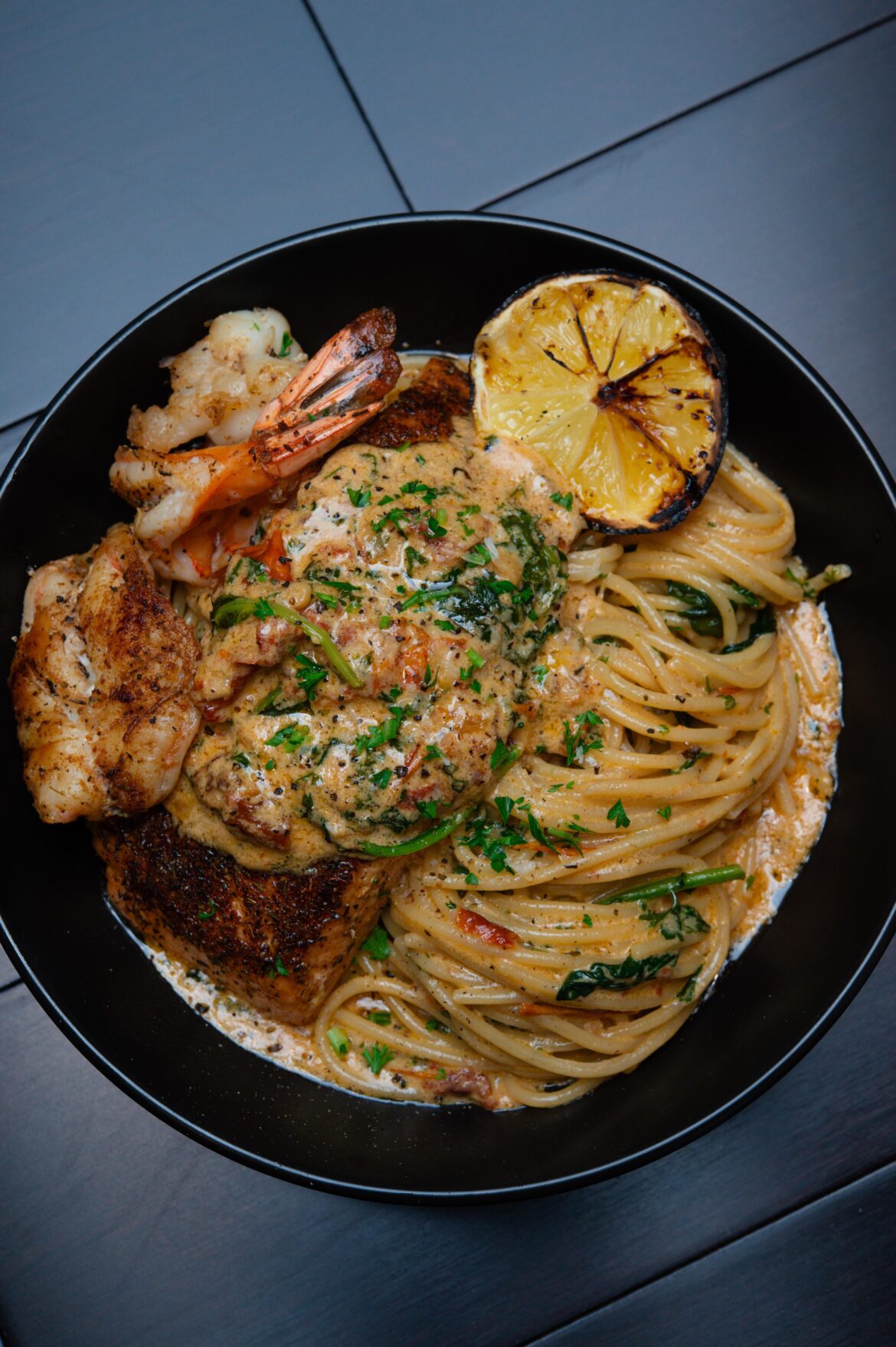 [homemade] Blackened salmon and shrimp Tuscan pasta.
