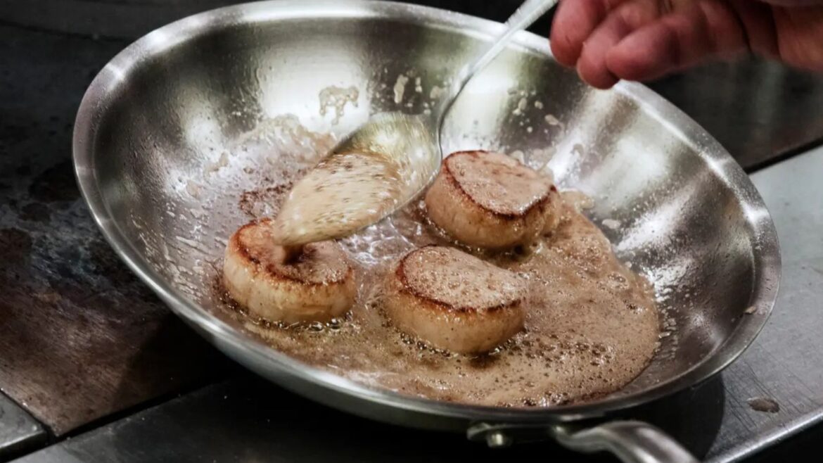 A Made In stainless steel pan cooking scallops in butter
