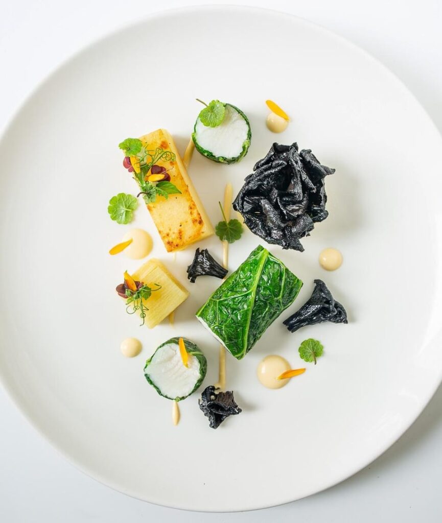 Black halibut, savoy cabbage, black trumpet mushrooms, potatoes au gratin, hollandaise sauce.