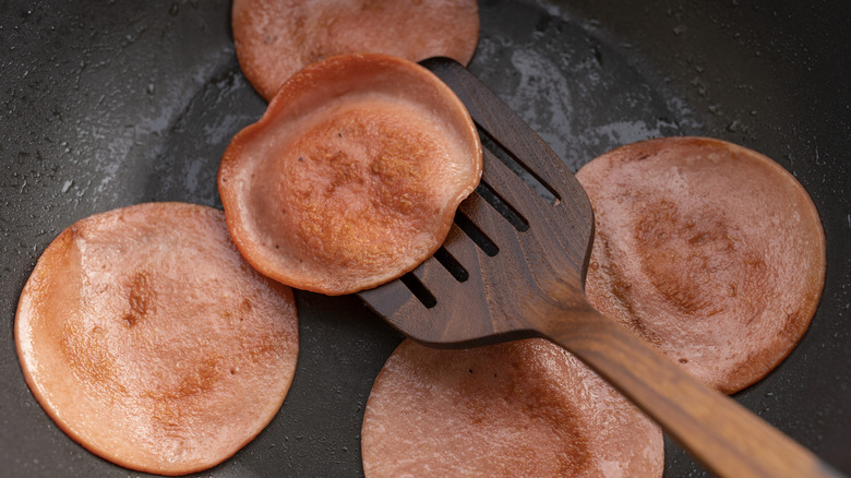 bologna frying in a pan