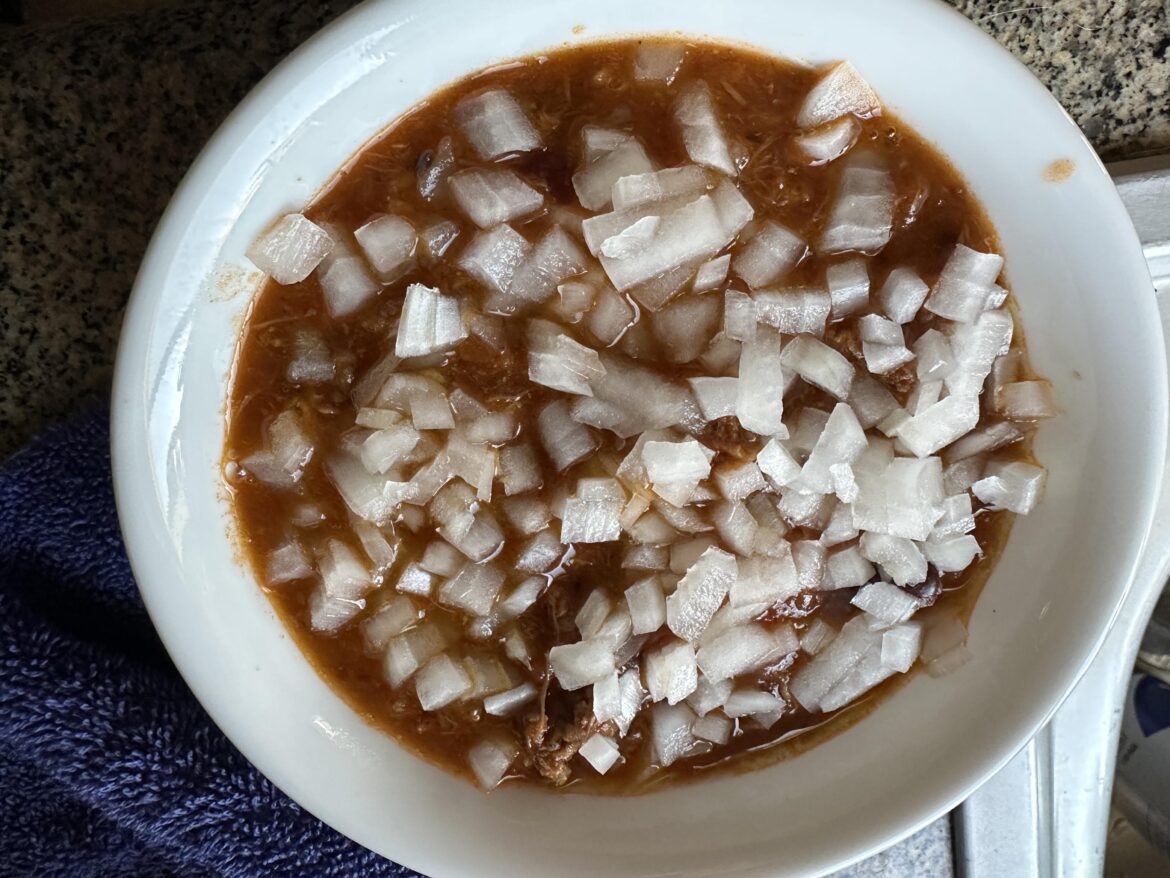 Freshly chopped white onion on chili!