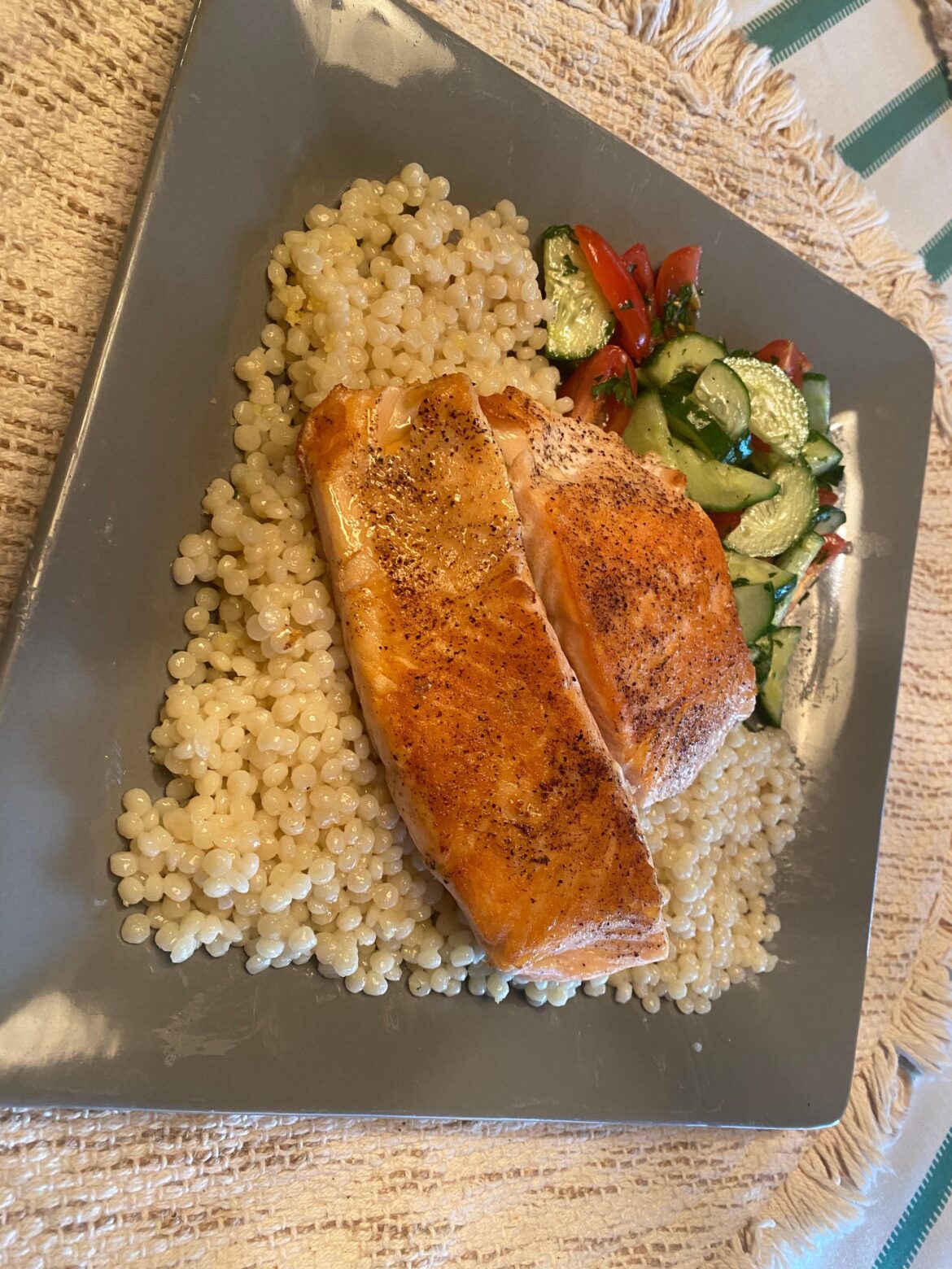 Seared salmon with lemony couscous and cucumber tomato salad