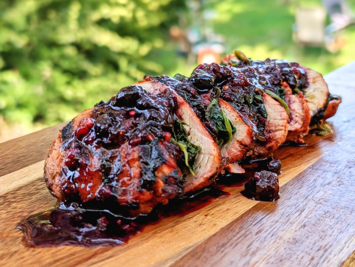 Stuffed pork tenderloin, smoked and charcoal grilled, topped with cooked spinach and a cran/blueberry balsamic reduction.
