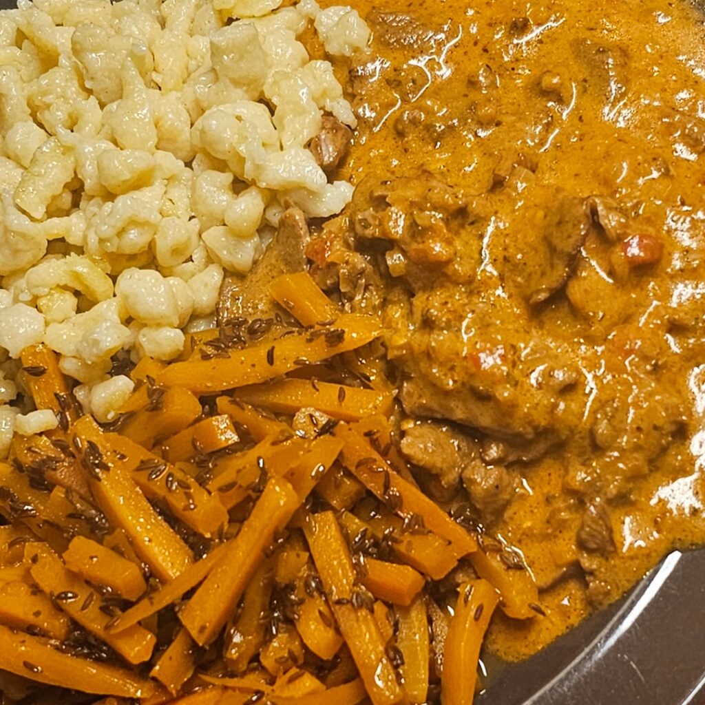 Pork strips with homemade Spätzle and carrots with caraway seeds