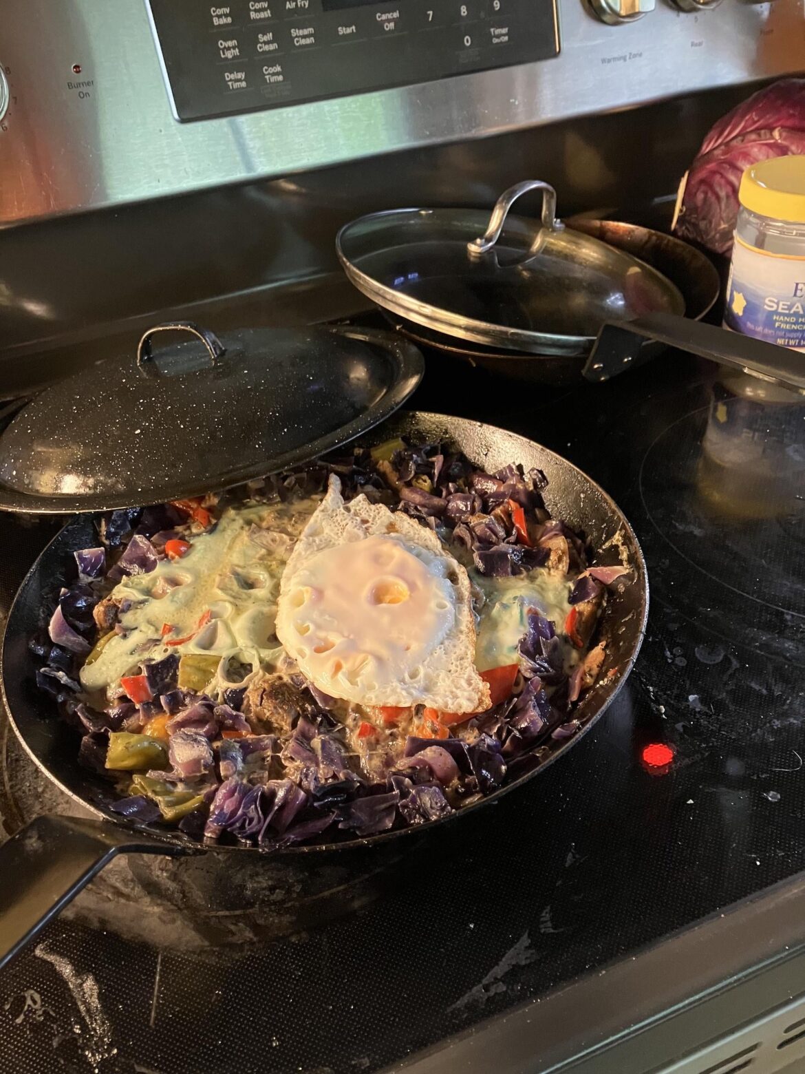 An egg (fried) on five egg whites (steamed) on cabbage and peppers (braised in chicken broth and cream) with ground turkey, onion and grape tomatoes (sautéed in butter).