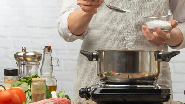 chef salting pasta water