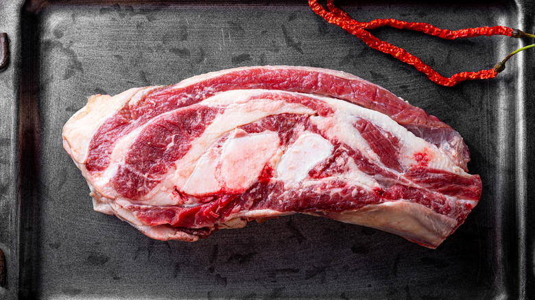 fresh raw brisket on sheet pan