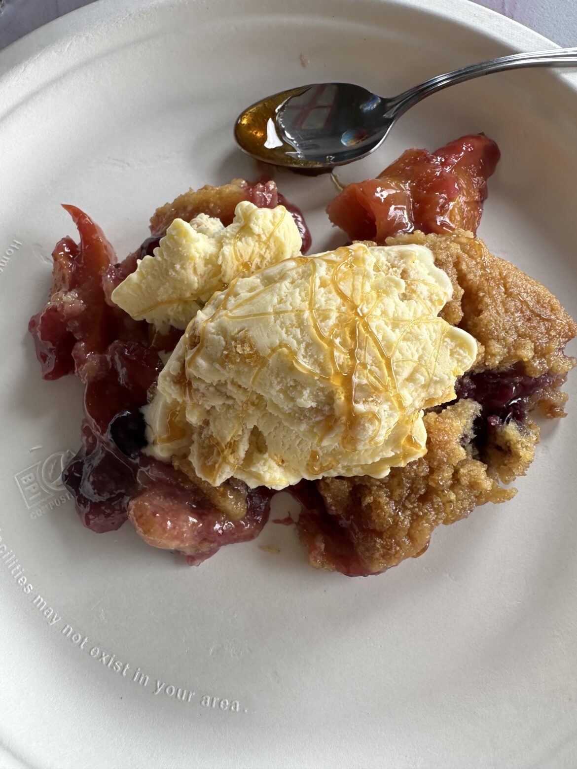 Blueberry, Peach Cornbread Cobbler with sweet corn ice cream and bourbon hot honey drizzle.