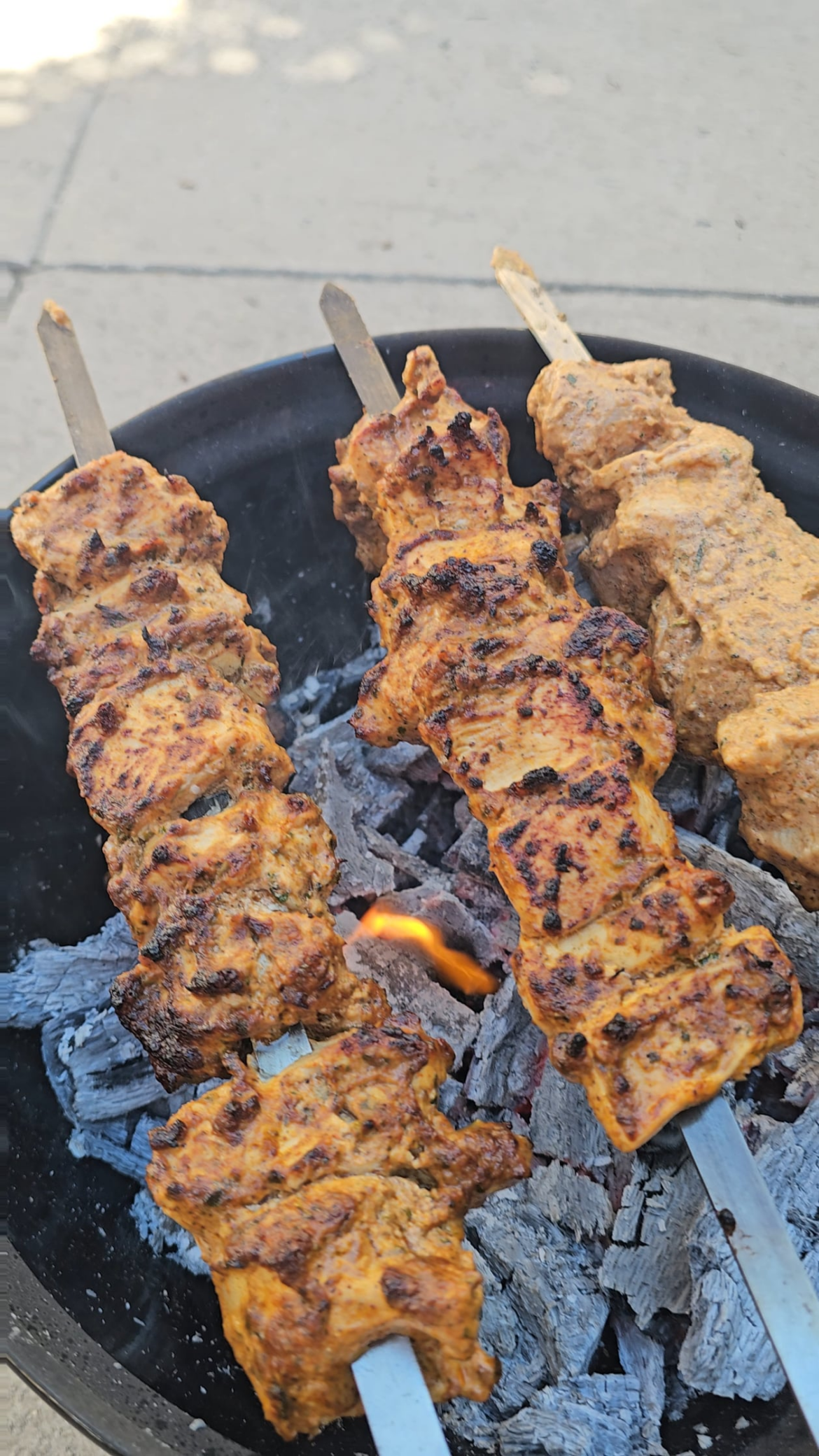 Yogurt marinated chicken skewers over a red oak fire
