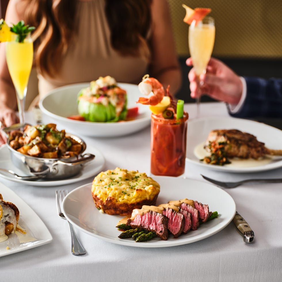 a table with plates of food and drinks on it