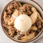 easy apple crisp with oats topped with a scoop of homemade vanilla ice cream