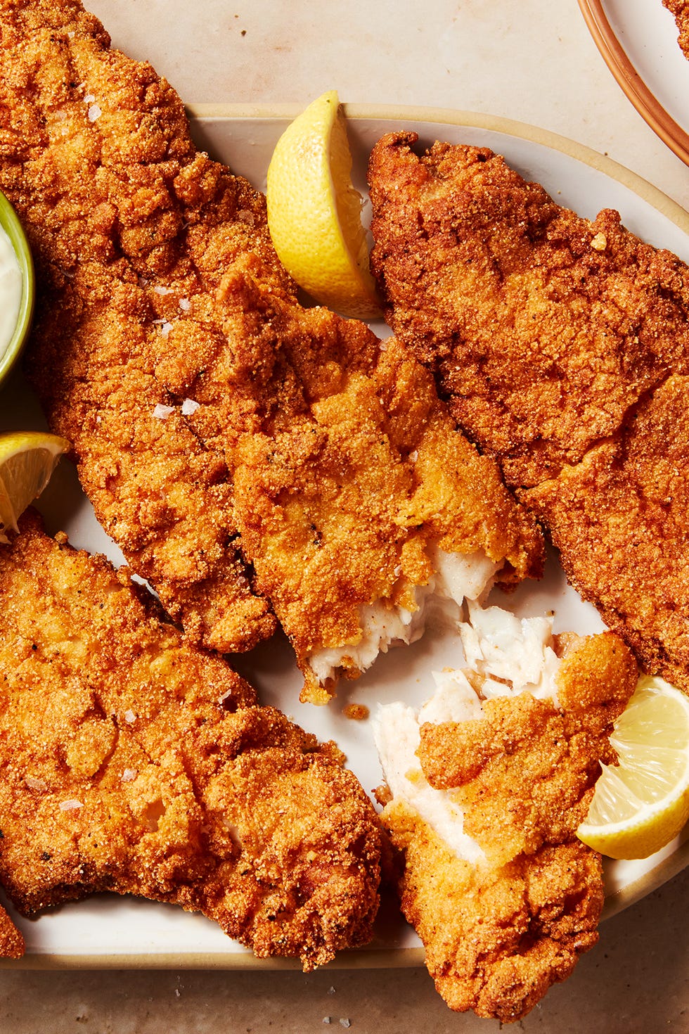 catfish battered and fried served with lemon wedges