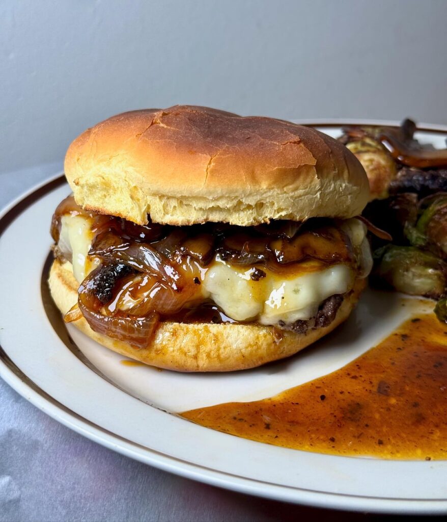 Demi glace Mushroom Swiss burger with caramelized onions and roasted Brussels sprouts.