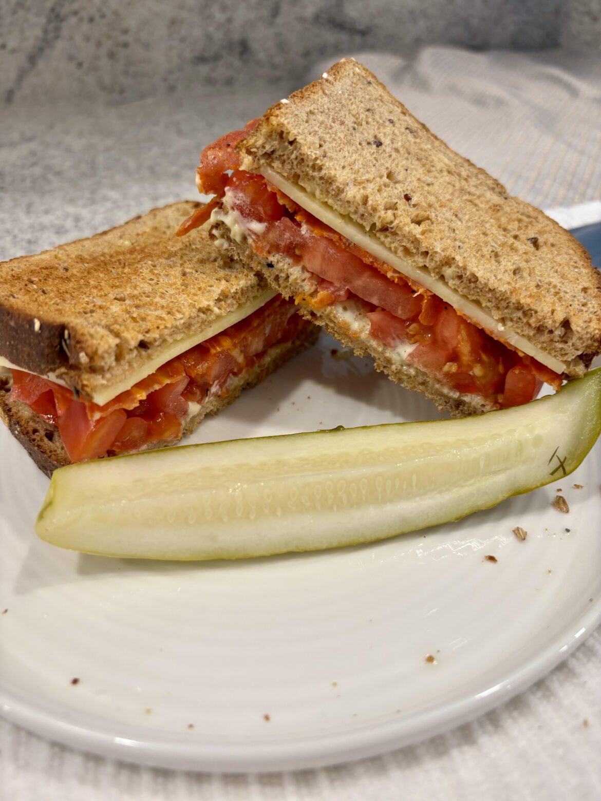 Simple yet satisfying spicy salami, cheddar, heirloom tomatoes seasoned with salt and pepper, mayo on seeded bread.