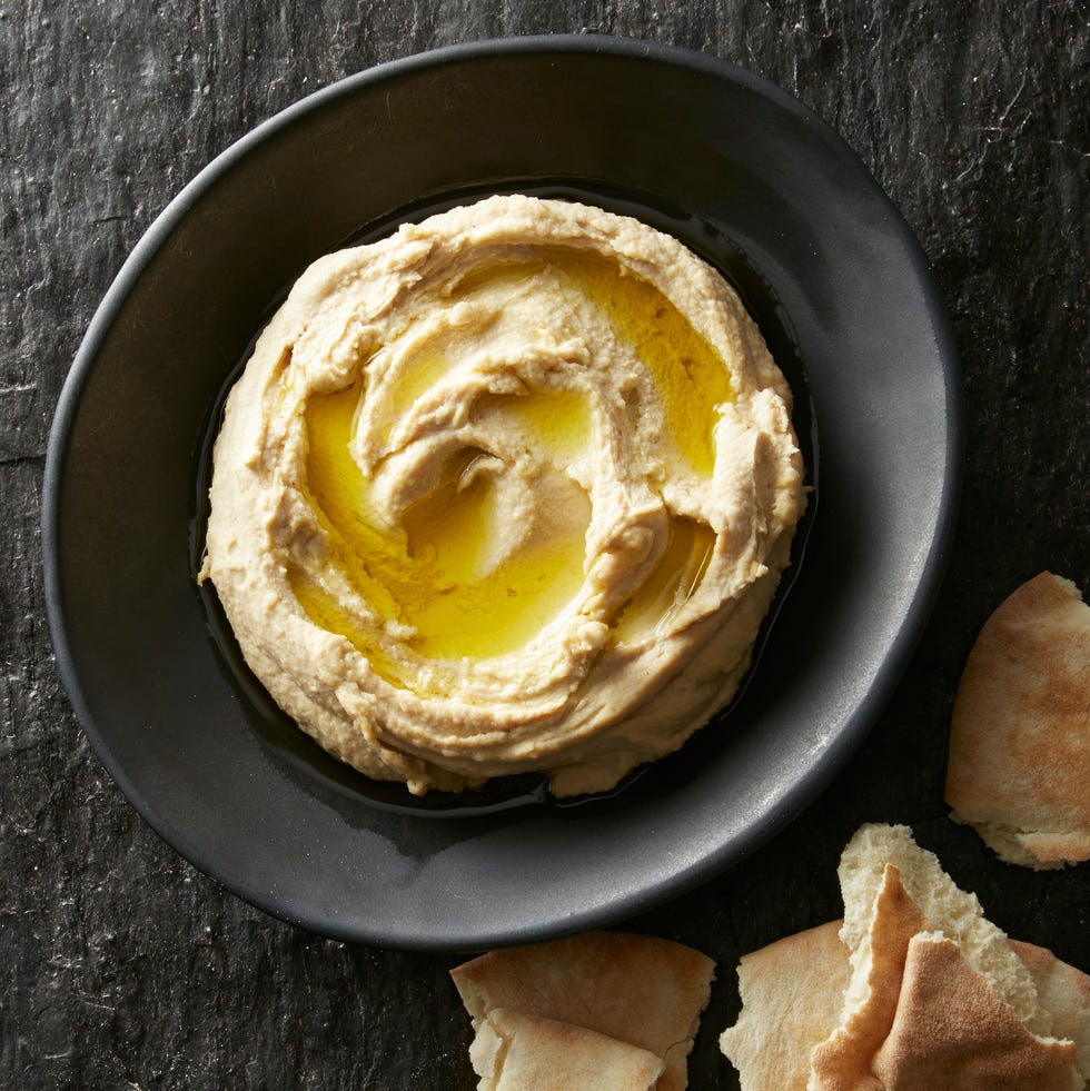 homemade hummus with torn pita on the side