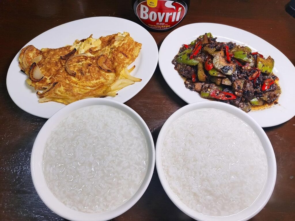 Rice porridge with Bovril, onion omelette, Fried Dace with Bittergourd in Fermented Black Beans 💗🤤
