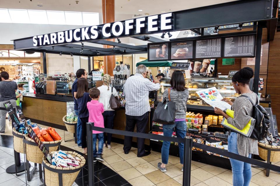 Customers at a Starbucks coffee shop in a mall.