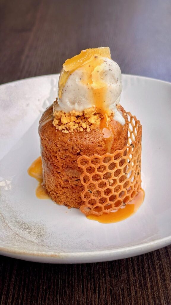 Brown butter spice cake filled with a pear cider compote served with a chai ice-cream, candied ginger, and a pear cider caramel.