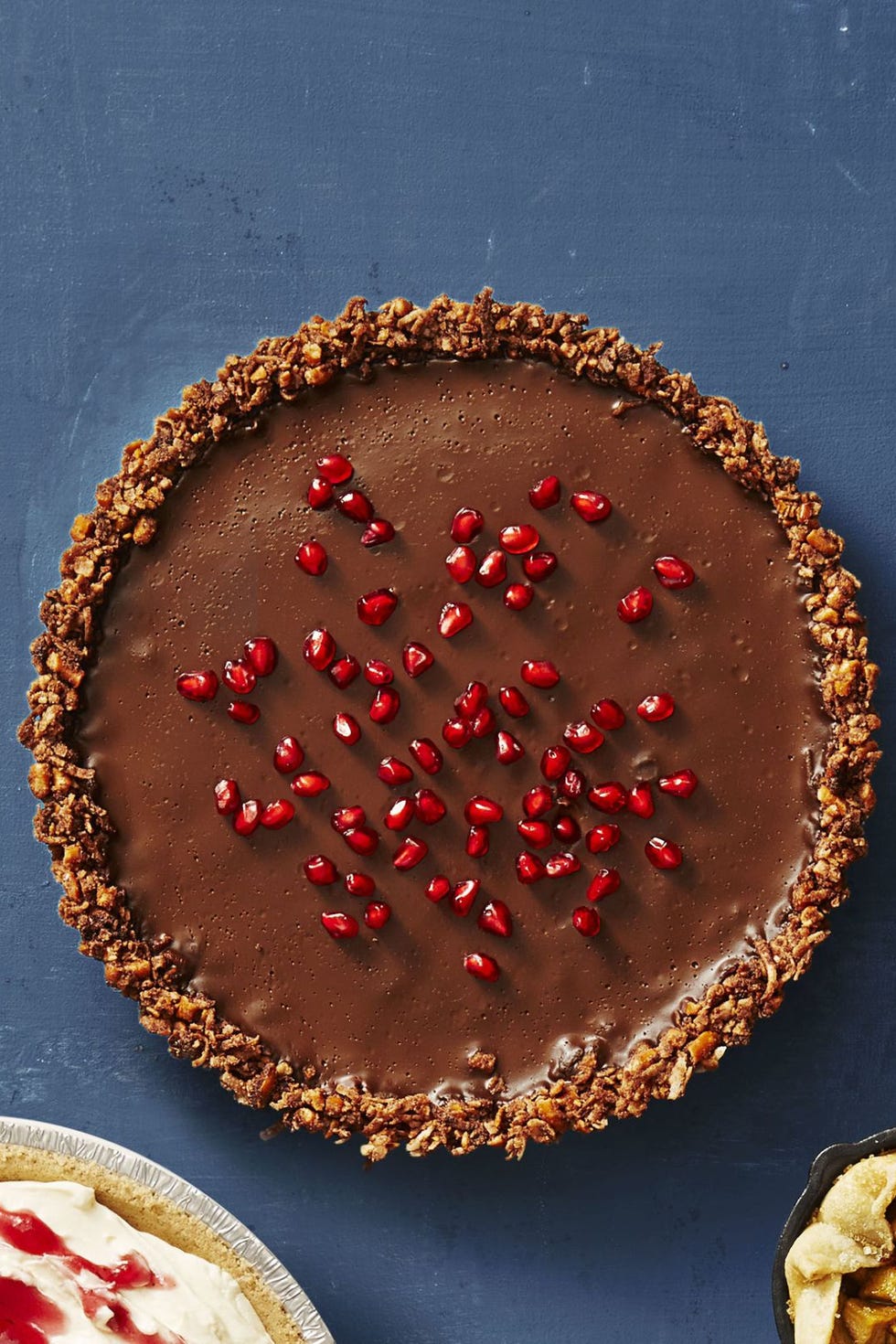 gluten free chocolate ganache tart on a blue background