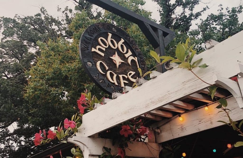 Image shows the exterior sign of the Hobbit Cafe in Houston