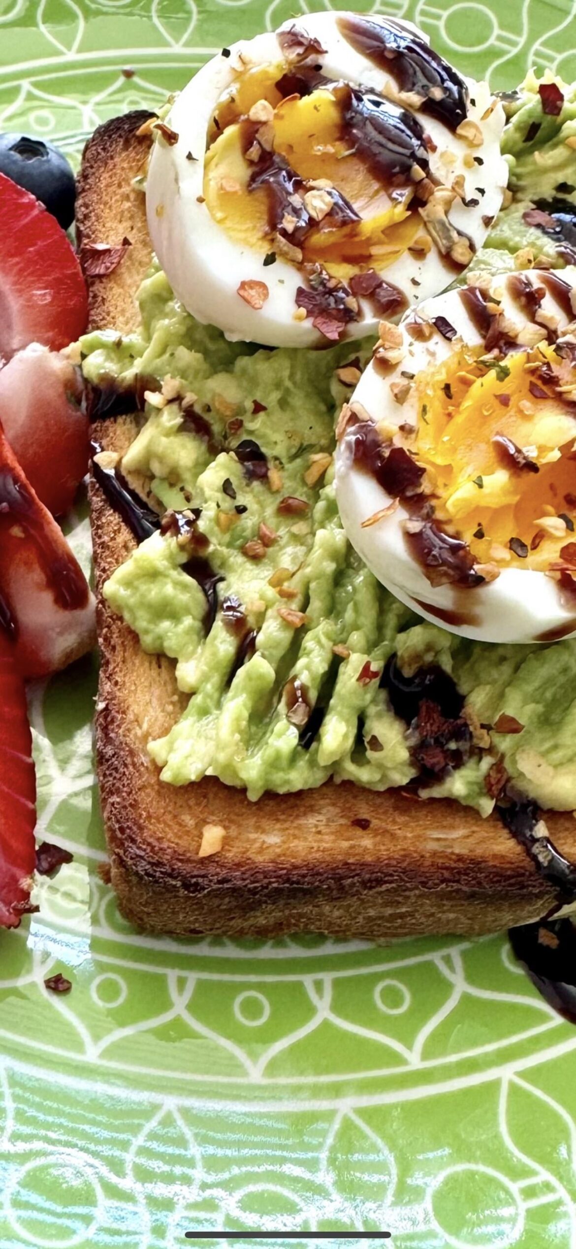 Sourdough toast, mashed avocado & boiled eggs topped w/ chili crisp and balsamic vinegar. Side of strawberries