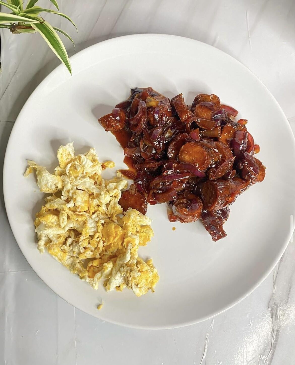 Scrambled eggs and Some fried sliced sausages