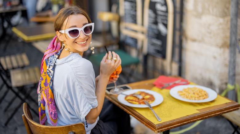 Woman eating at Italian restaurant