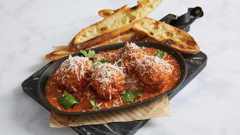 three big meatballs served with crostini