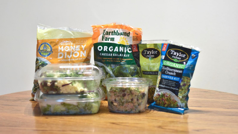 A selection of Costco salad kits on a wooden table