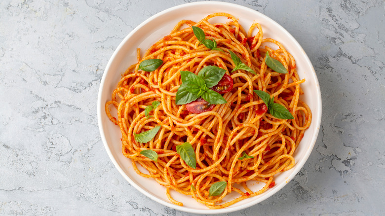 An illustrative image showing a bowl of pasta with tomato sauce.