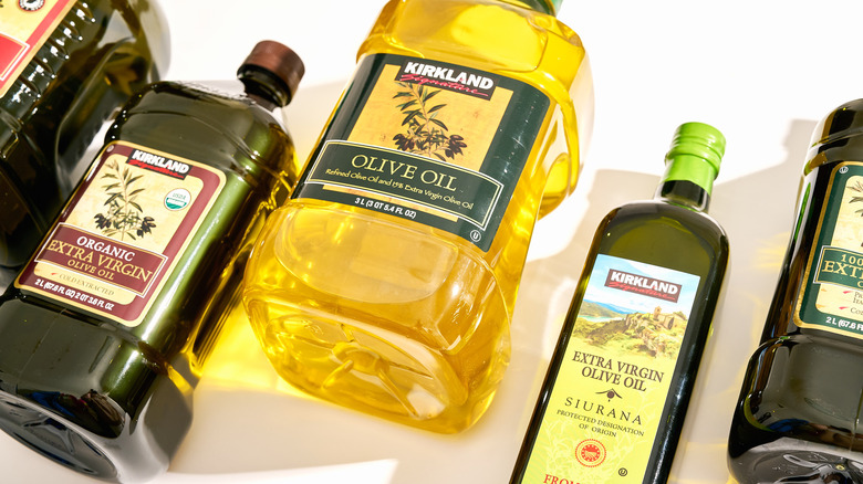 Costco olive oil bottles spread on a white table
