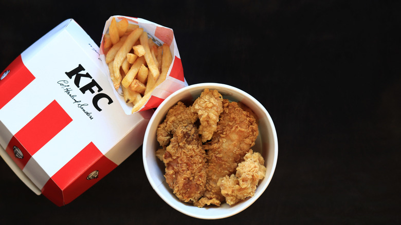 KFC. Bucket with strips, burger in paper box and french fries.