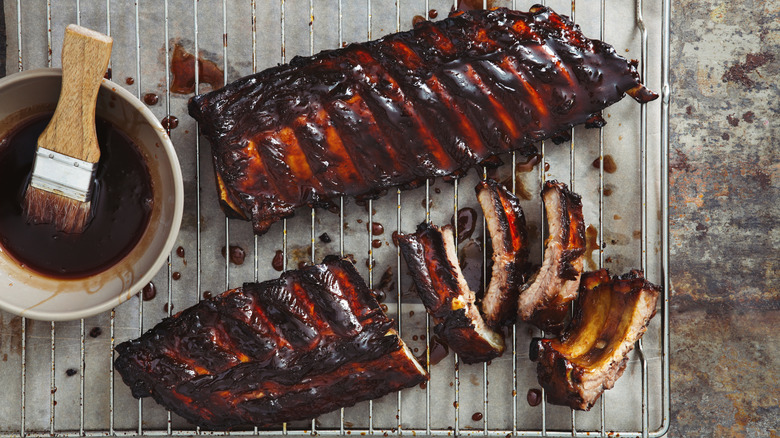 Two racks of ribs arranged on a baking sheet.