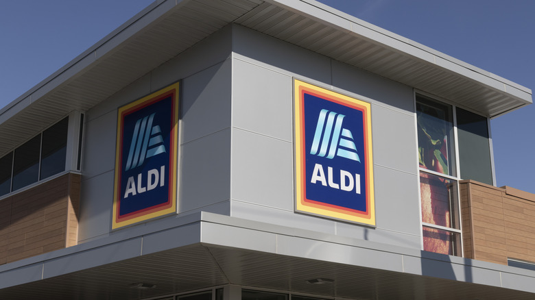 The corner of an Aldi building with one logo on either side