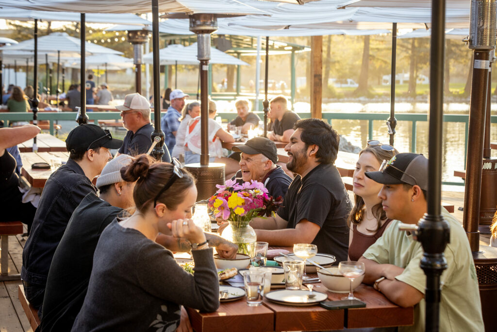 Group tables on the large patio at sunset at the Waterhawk Lake Club Thursday, August 14, 2025, in Rohnert Park. (John Burgess / The Press Democrat)