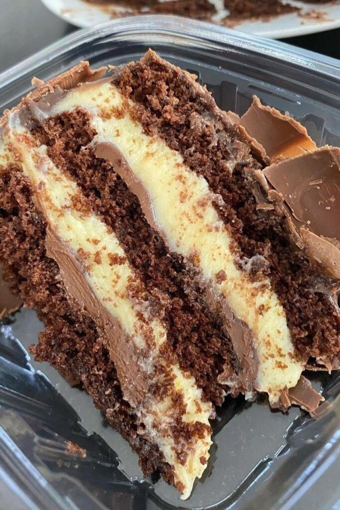 Chocolate layer cake with vanilla custard filling and chocolate ganache.