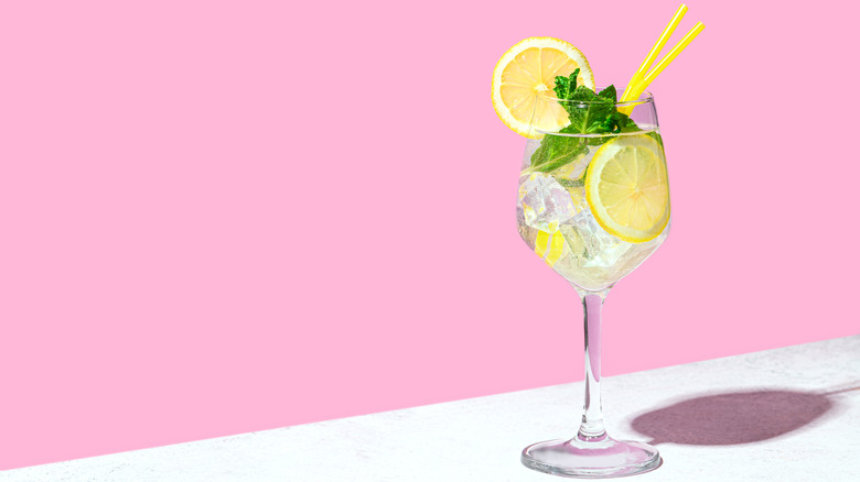 Hugo spritz cocktail against pink background