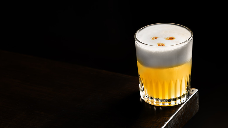 Pisco sour on black background