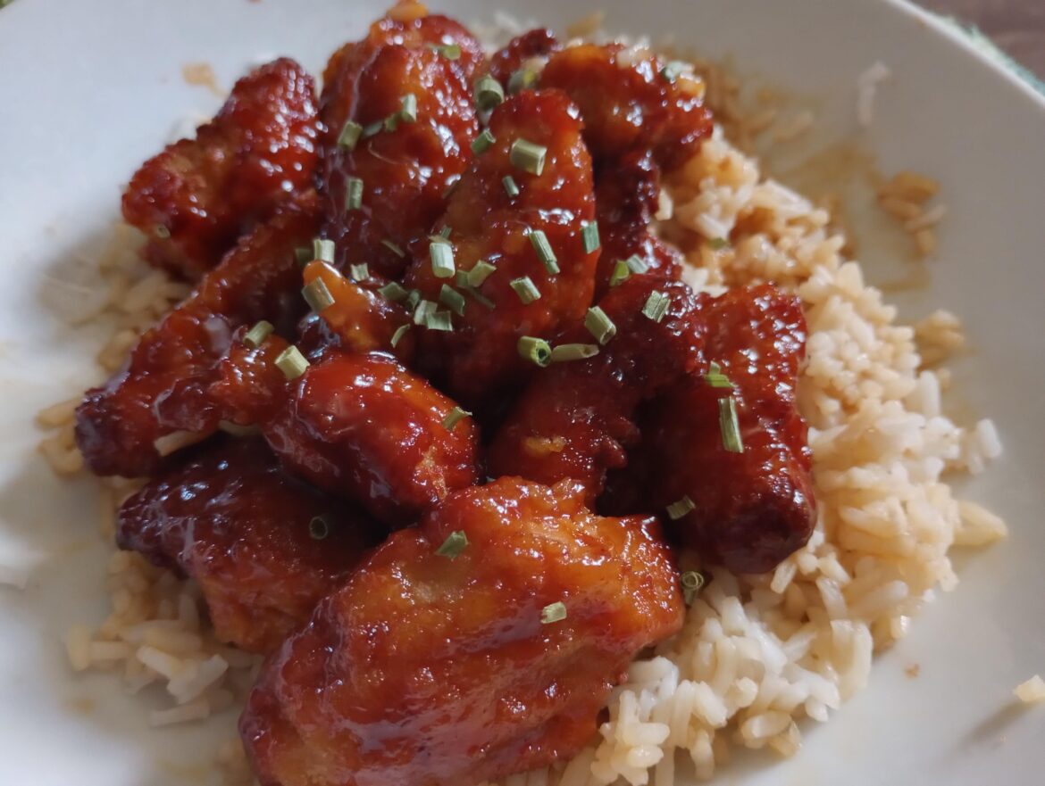 Mega Dino Nuggets sliced and tossed in bottled General Tso sauce, on a bed of white rice swimming in soy sauce.