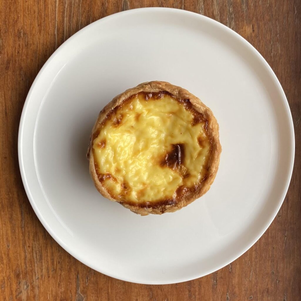 Macau-style Portuguese egg tart from Xin Fa Bakery in Sunset Park, Brooklyn. Thick, creamy, melt-in-your-mouth custard with a buttery crisp crust. High turnover so it usually comes out hot and fresh.
