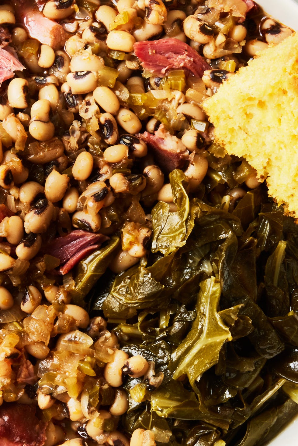 new year's style black eyed peas with pork neck bones and collard greens served with corn bread
