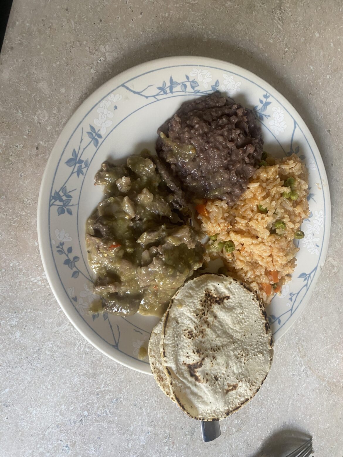Carnita con chile, homemade Mexican rice and tortillas. Refried black beans from a can..