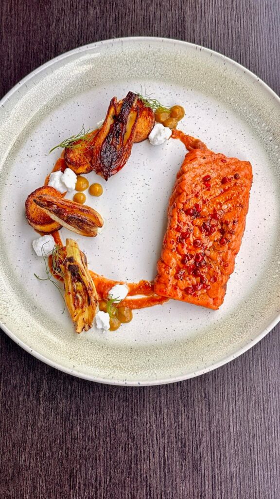 Salmon with pink peppercorn & lemon, ratatouille sauce, fresh fennel, sumac butternut squash medallions, ras el handout onion purée, and feta.