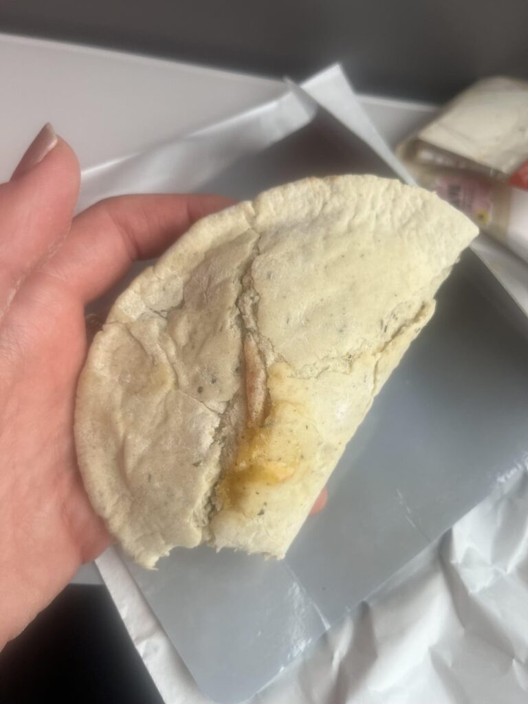 “Calzone pizza” I was just served. Yes, that dough tastes as raw as it looks, yes , I am still eating it, and yes, I am ashamed.