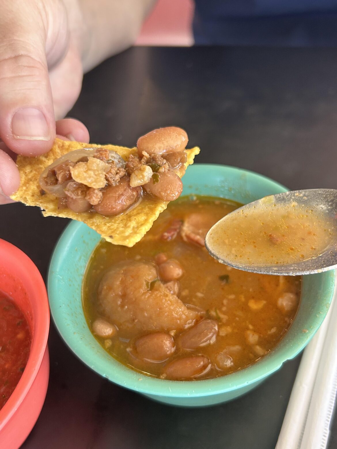 Are the cup of beans that come with the chips and salsa at this Mexican restaurant for dipping chips or eating with a spoon?