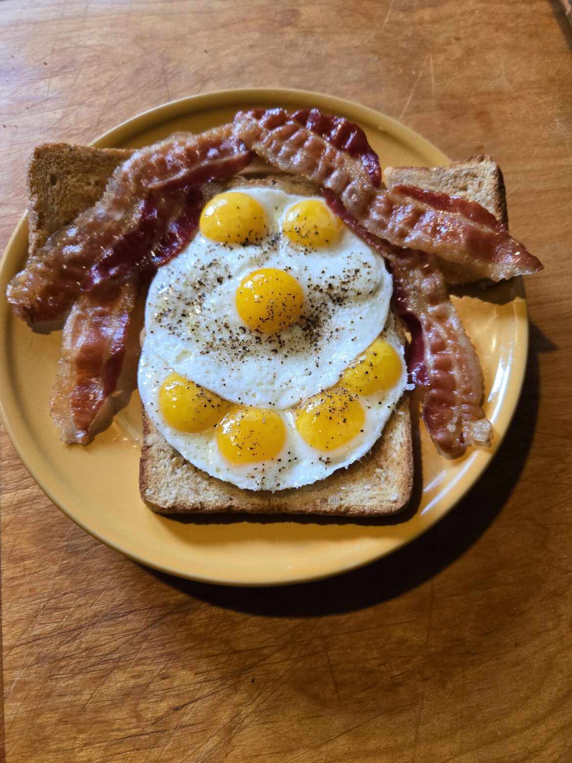 Quail eggs, bacon and toast.