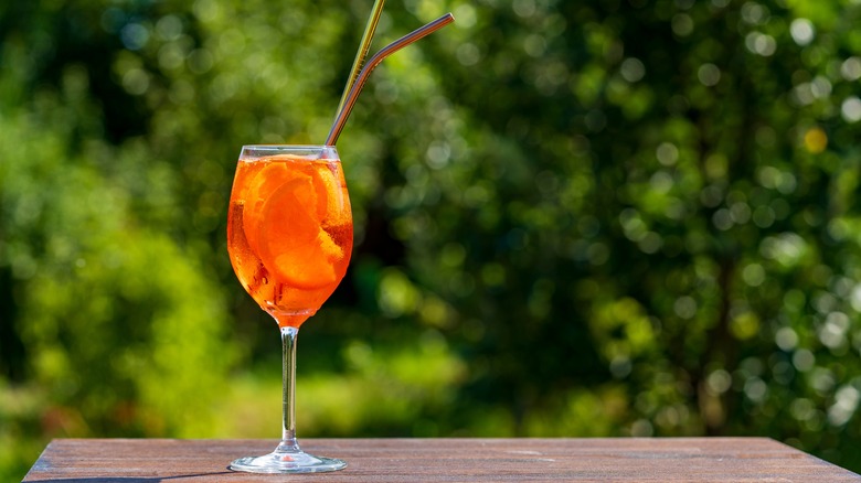 Aperol spritz against greenery backdrop