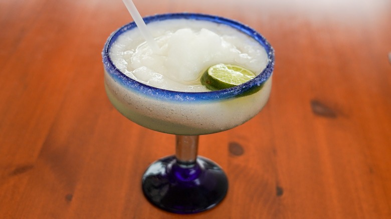 Frozen margarita on wooden table