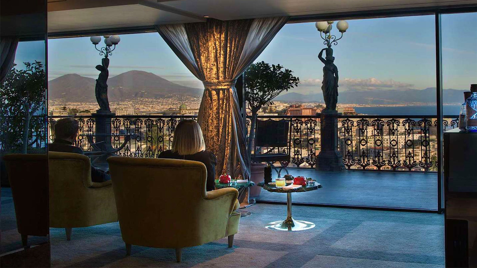  People dining on a landing at George Restaurant in Naples, with a view of Naples